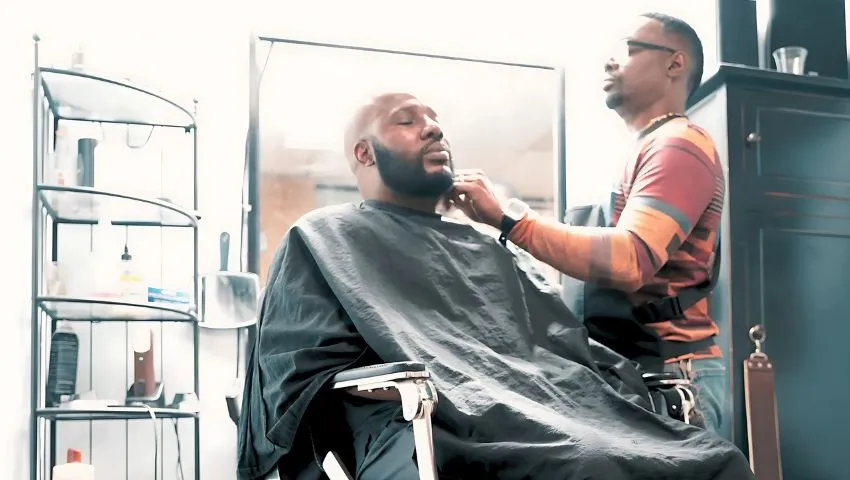 Barber Donald Hyder trims the beard of Richard Lawrence, who is not a Harvest Trauma client. Image credit: Corey Hopkins.