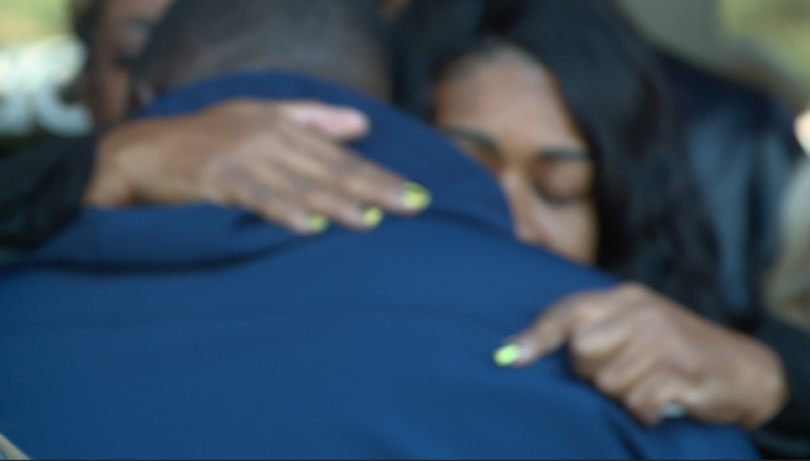 Survivor, Clarence Watson embraced after emotional speech during Harvest Trauma Recovery Center open. (KXAN photos/Tim Holcomb ).